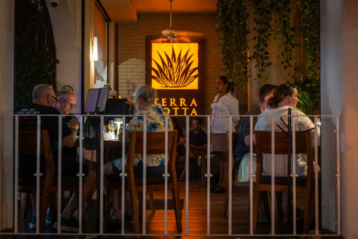 Terra Cotta exterior at night with glowing logo sign
